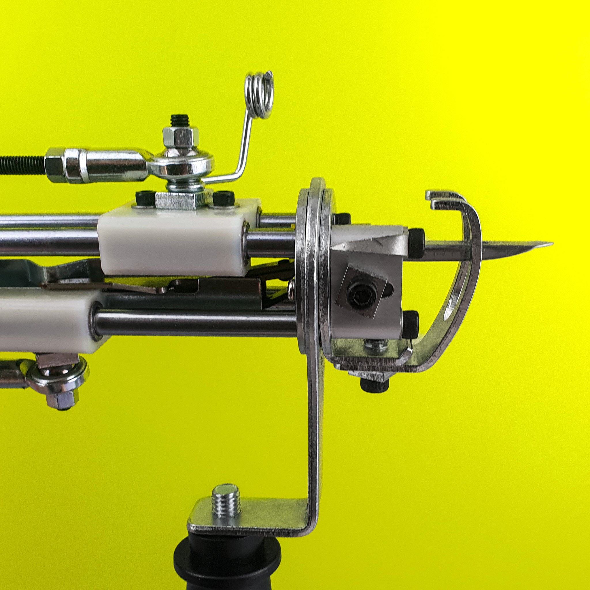 Side profile of AK-I tufting macine on green background