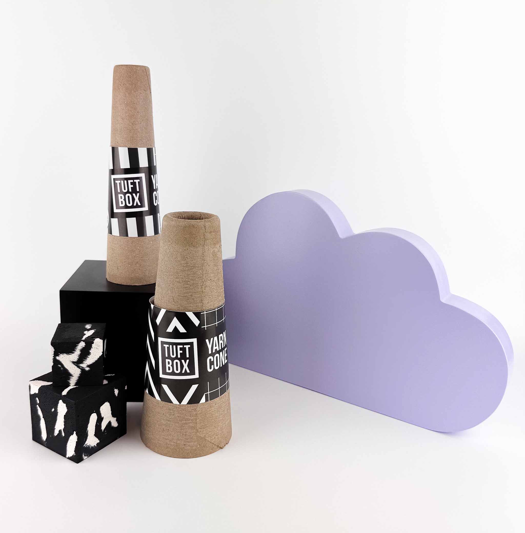 Yarn cones on a white background with purple cloud