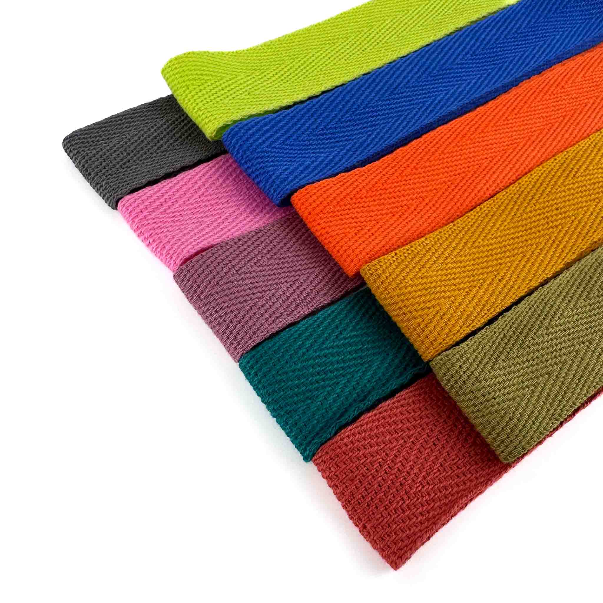 Colorful woven cotton herringbone twill tapes on a white background