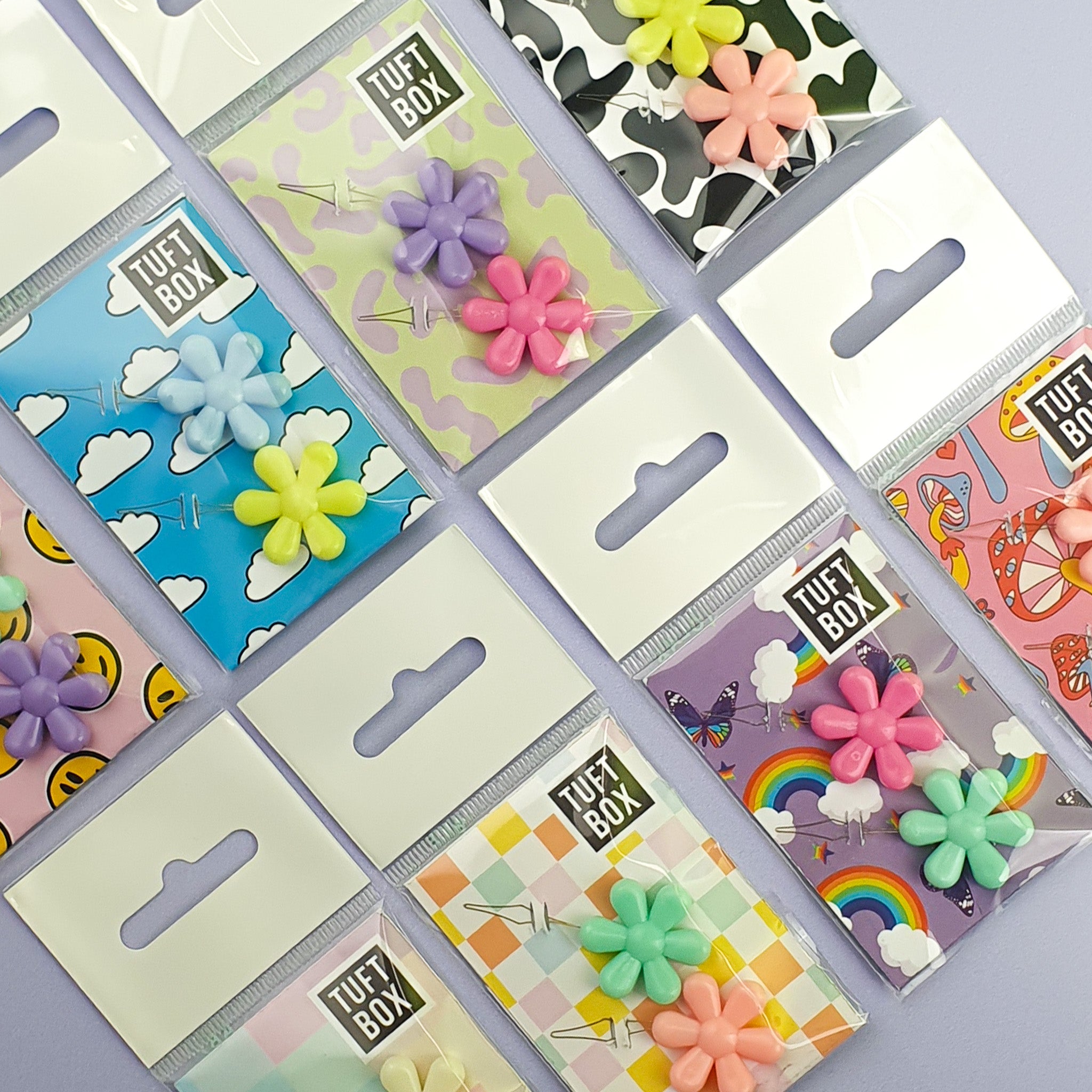 Flower Needle Threaders multiple packs laid out on purple backdrop