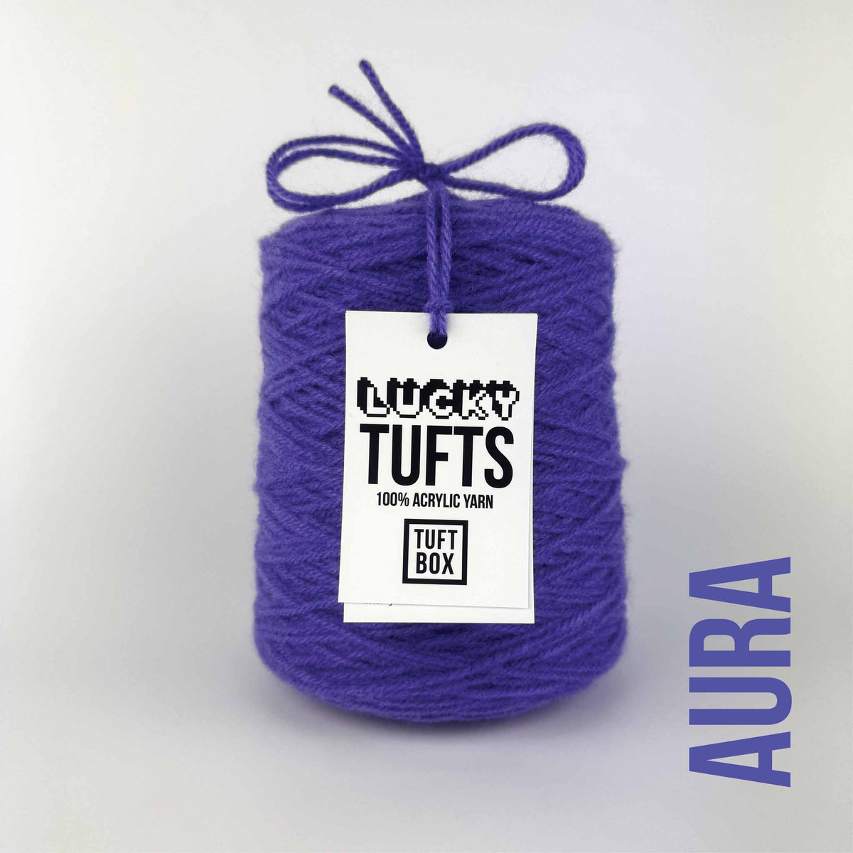 A cone of Lucky Tufts™ acrylic tufting and punch needle yarn in the colour Aura. An aquatic , vibrant blue.