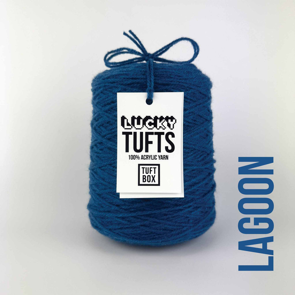A cone of Lucky Tufts™ acrylic tufting and punch needle yarn in the colour Lagoon. A deep and dynamic blue.