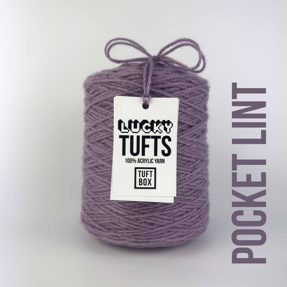 A cone of Lucky Tufts™ acrylic tufting and punch needle yarn in the colour Pocket Lint. A dry and cool mauve.