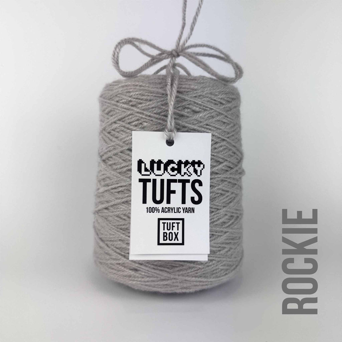A cone of Lucky Tufts™ acrylic tufting and punch needle yarn in the colour Rockie a warm light grey