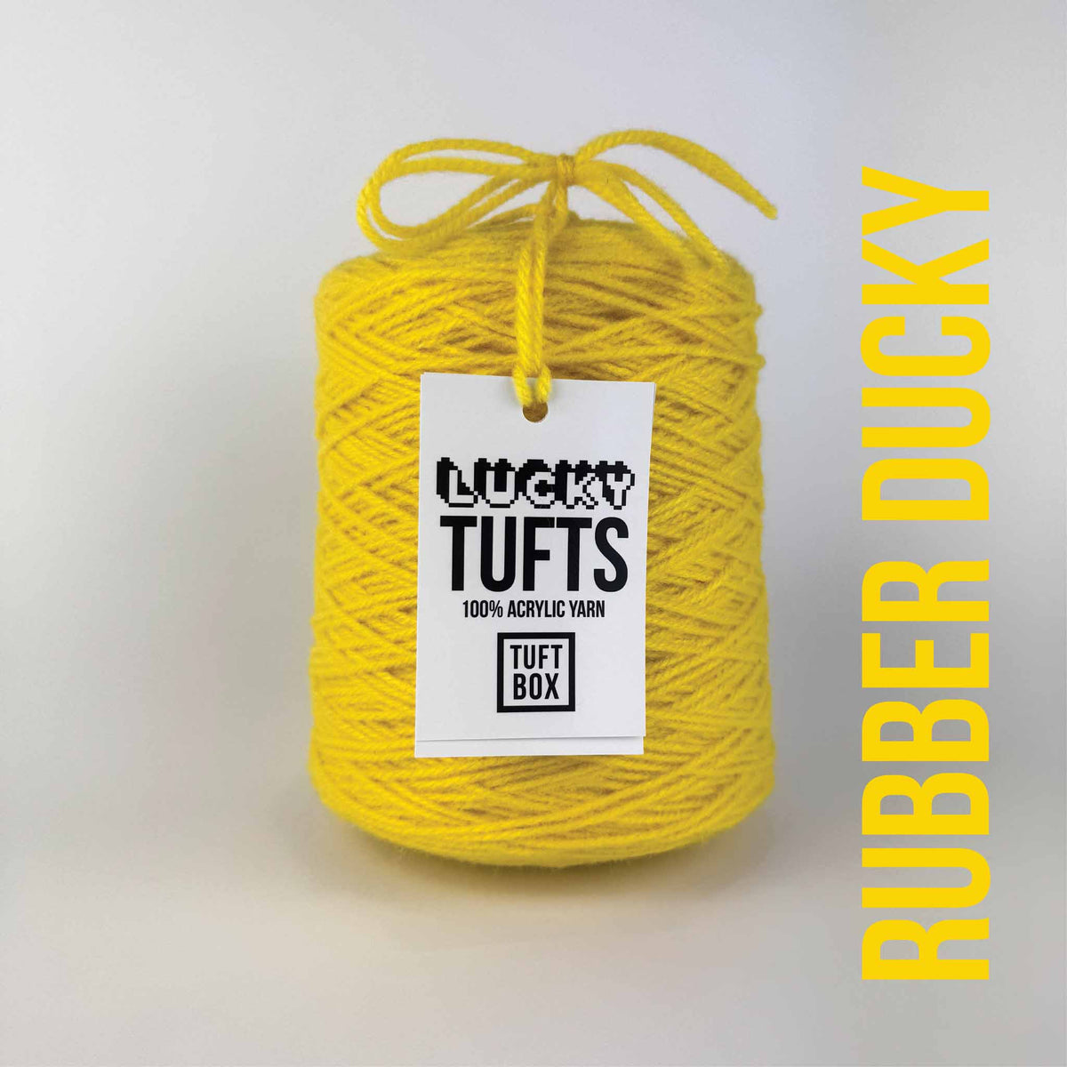 A cone of Lucky Tufts™ acrylic tufting and punch needle yarn in the colour Rubber Ducky. A bright and demanding yellow.