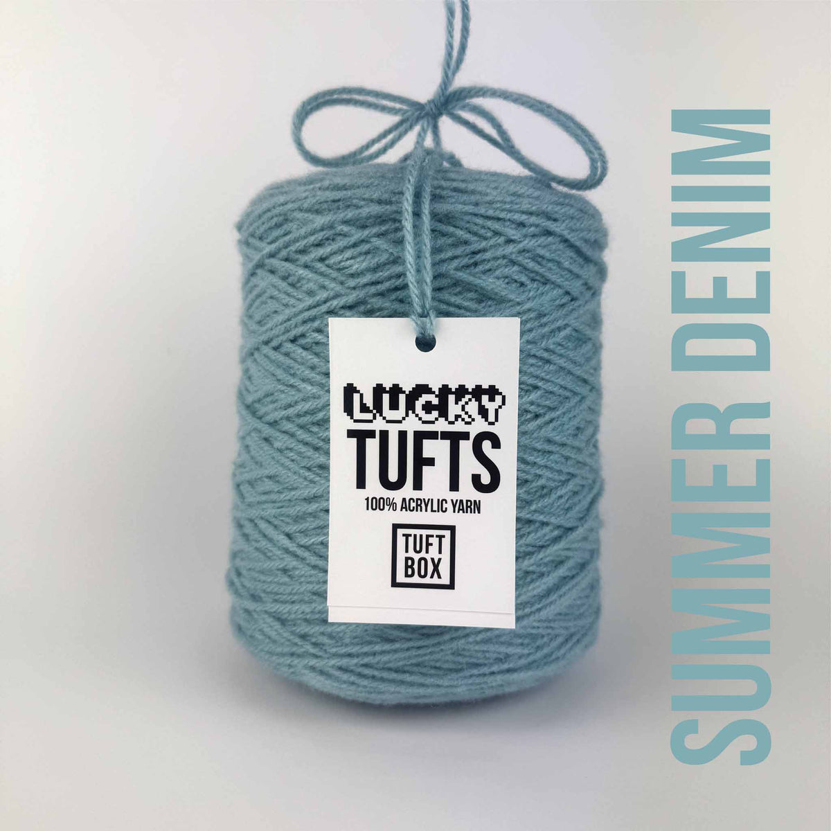 A cone of Lucky Tufts™ acrylic tufting and punch needle yarn in the colour Summer Denim. A strong pastel blue.