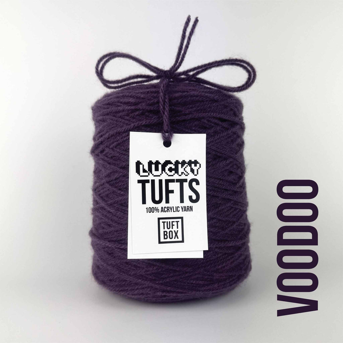 A cone of Lucky Tufts™ acrylic tufting and punch needle yarn in the colour Voodoo. A muddy purple.