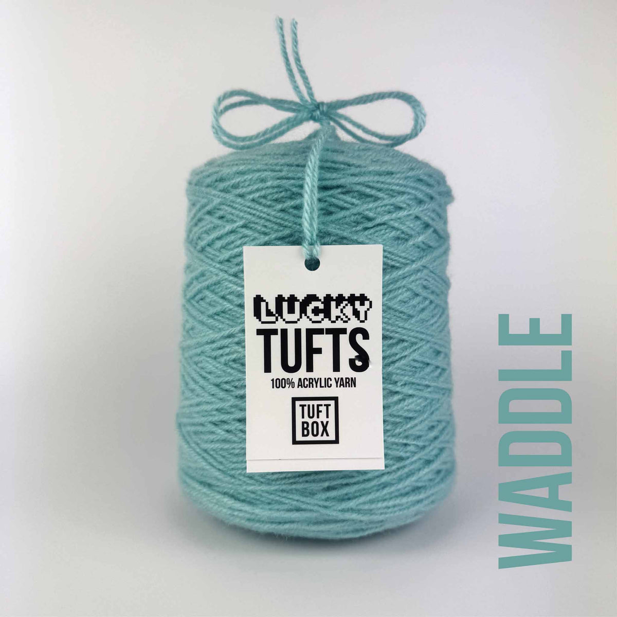 A cone of Lucky Tufts™ acrylic tufting and punch needle yarn in the colour Waddle. A pale mix of blue and green.