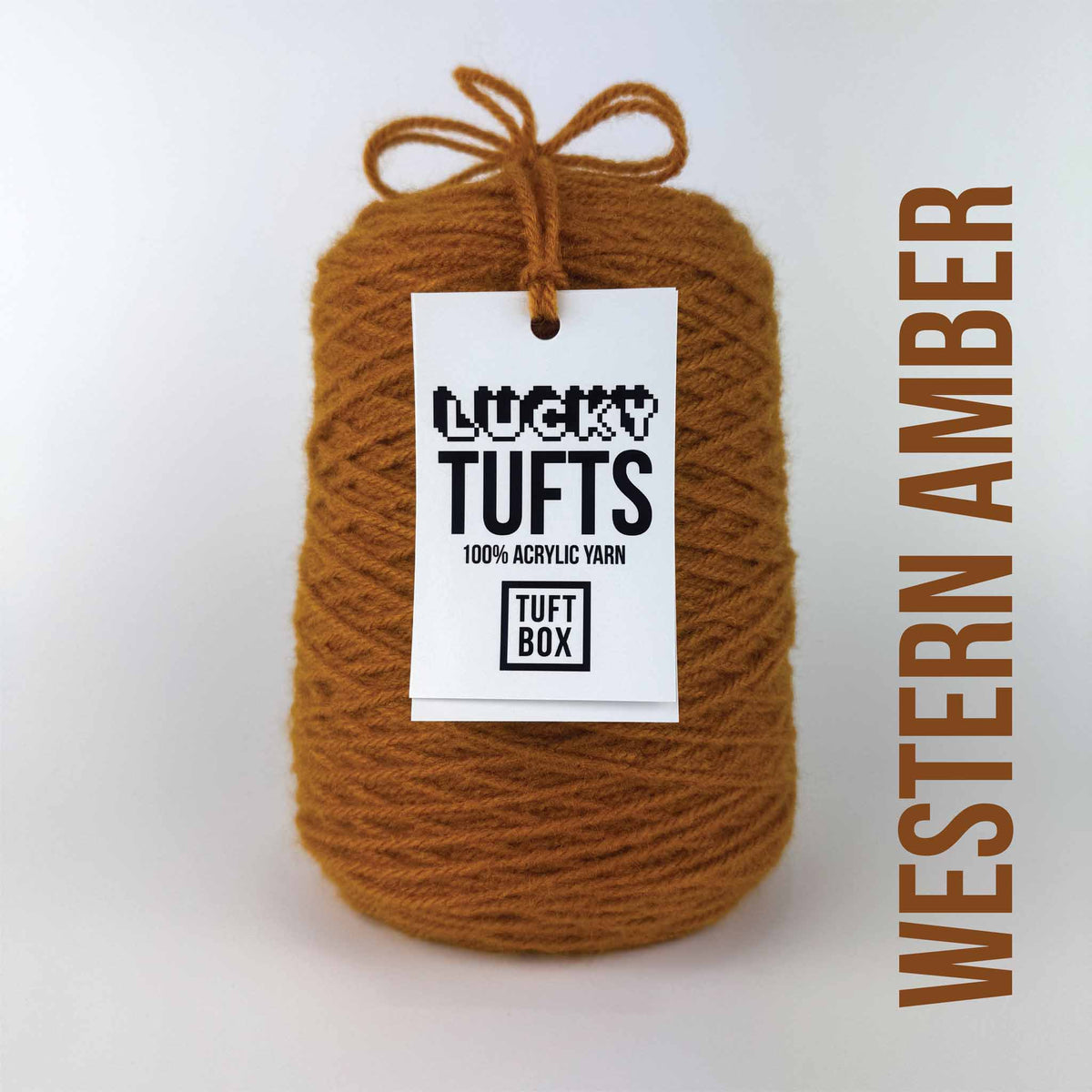 A cone of Lucky Tufts™ acrylic tufting and punch needle yarn in the colour Western Amber a dark brown orange