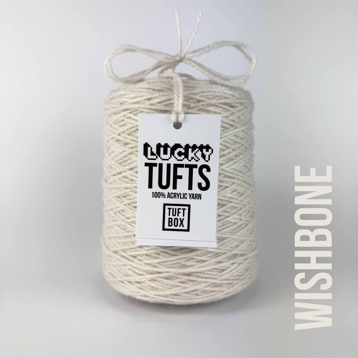 A cone of Lucky Tufts™ acrylic tufting and punch needle yarn in the colour Wishbone a cool toned off-white