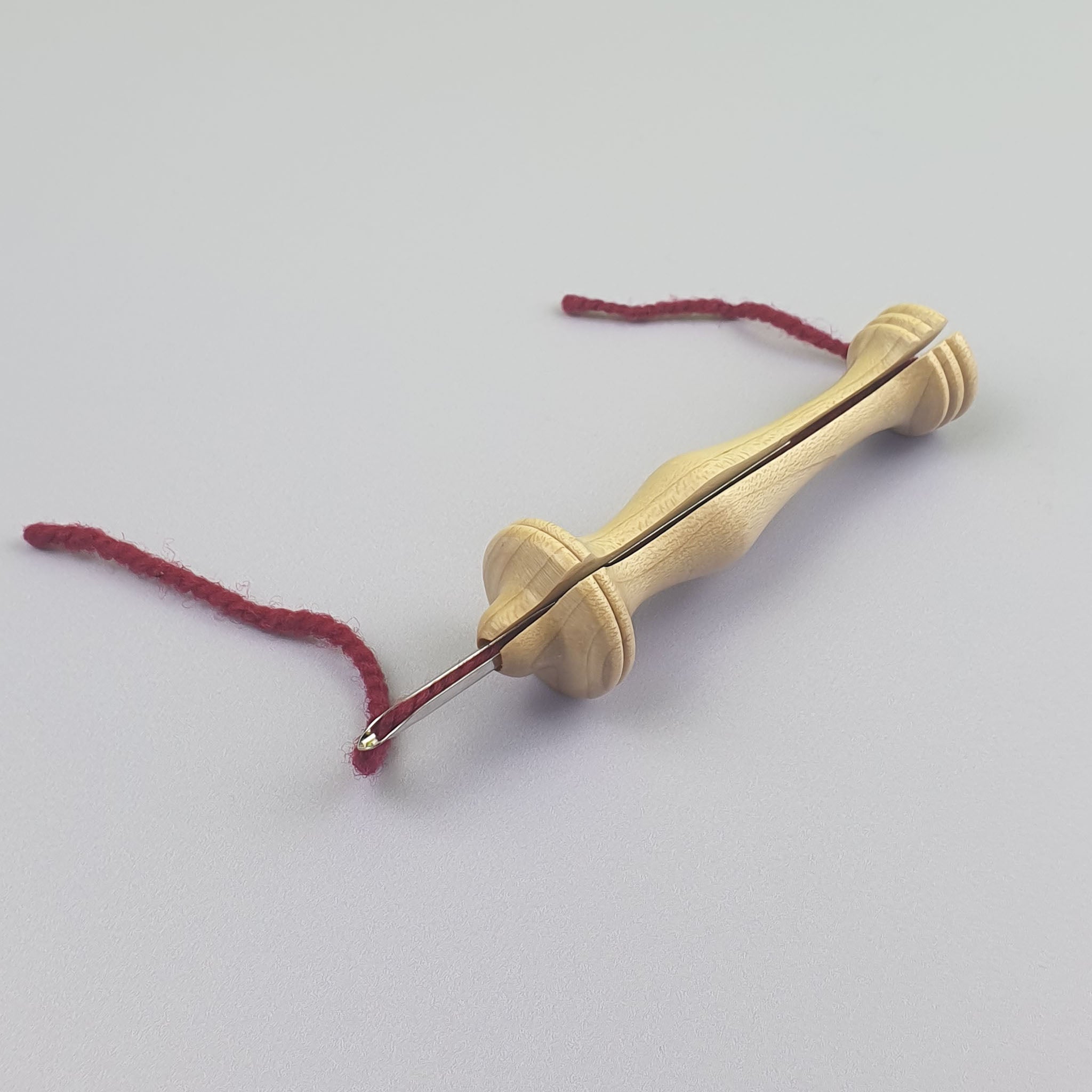 Oxford Punch Needle with red yarn threaded