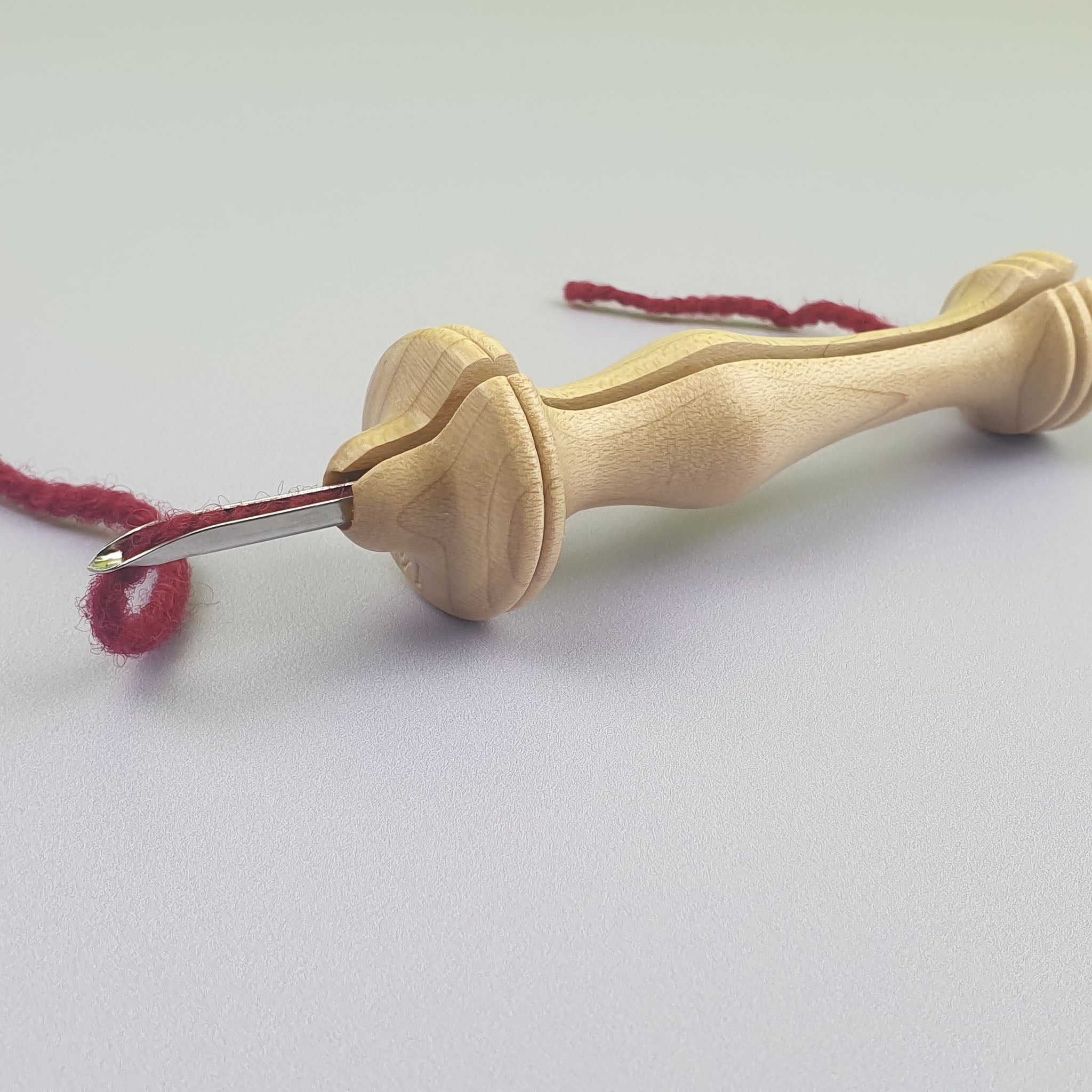 Oxford Punch Needle with red yarn threaded