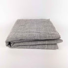 Grey Primary Rug Tufting Fabric swatches folded on a white background