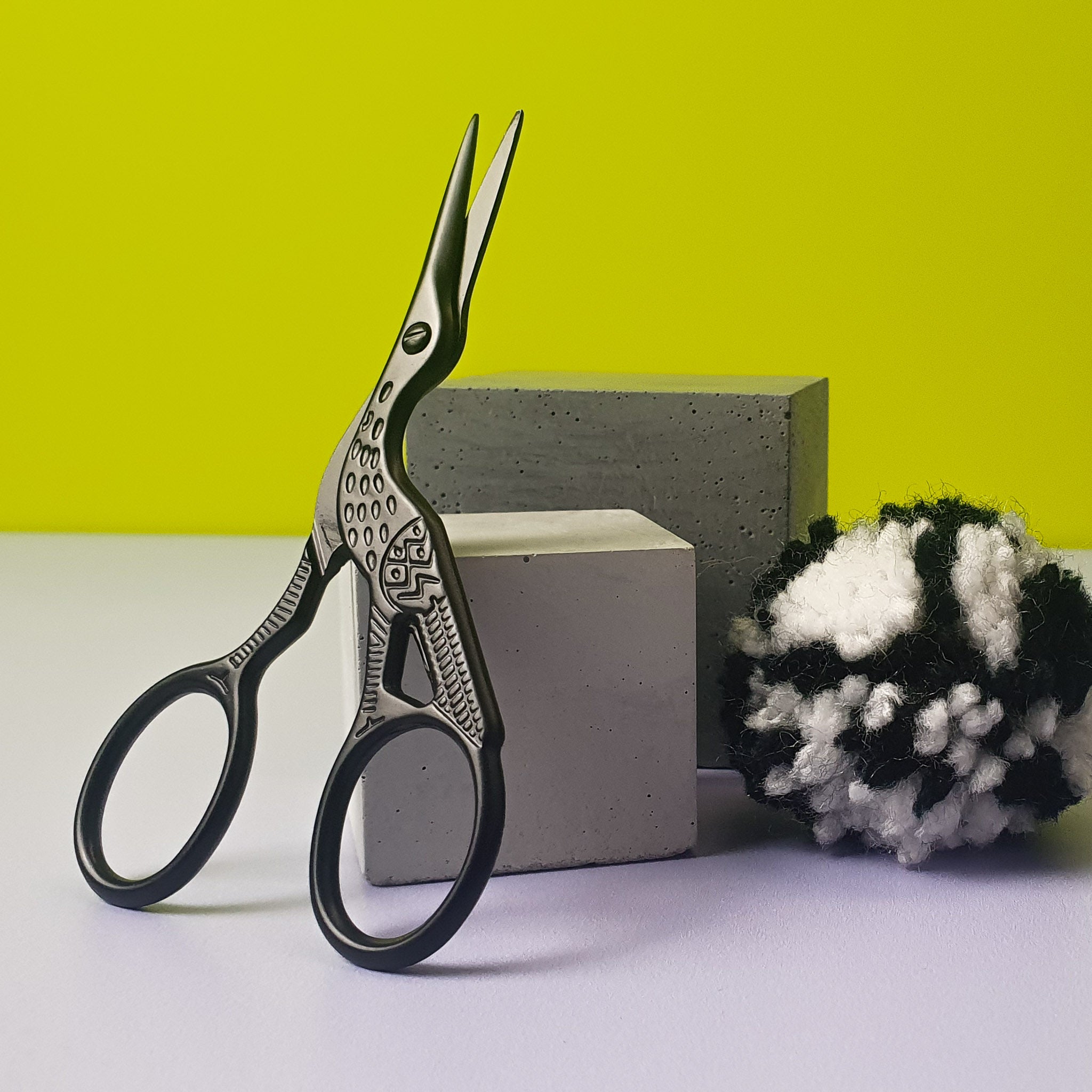 black crane embroidery scissors on blocks