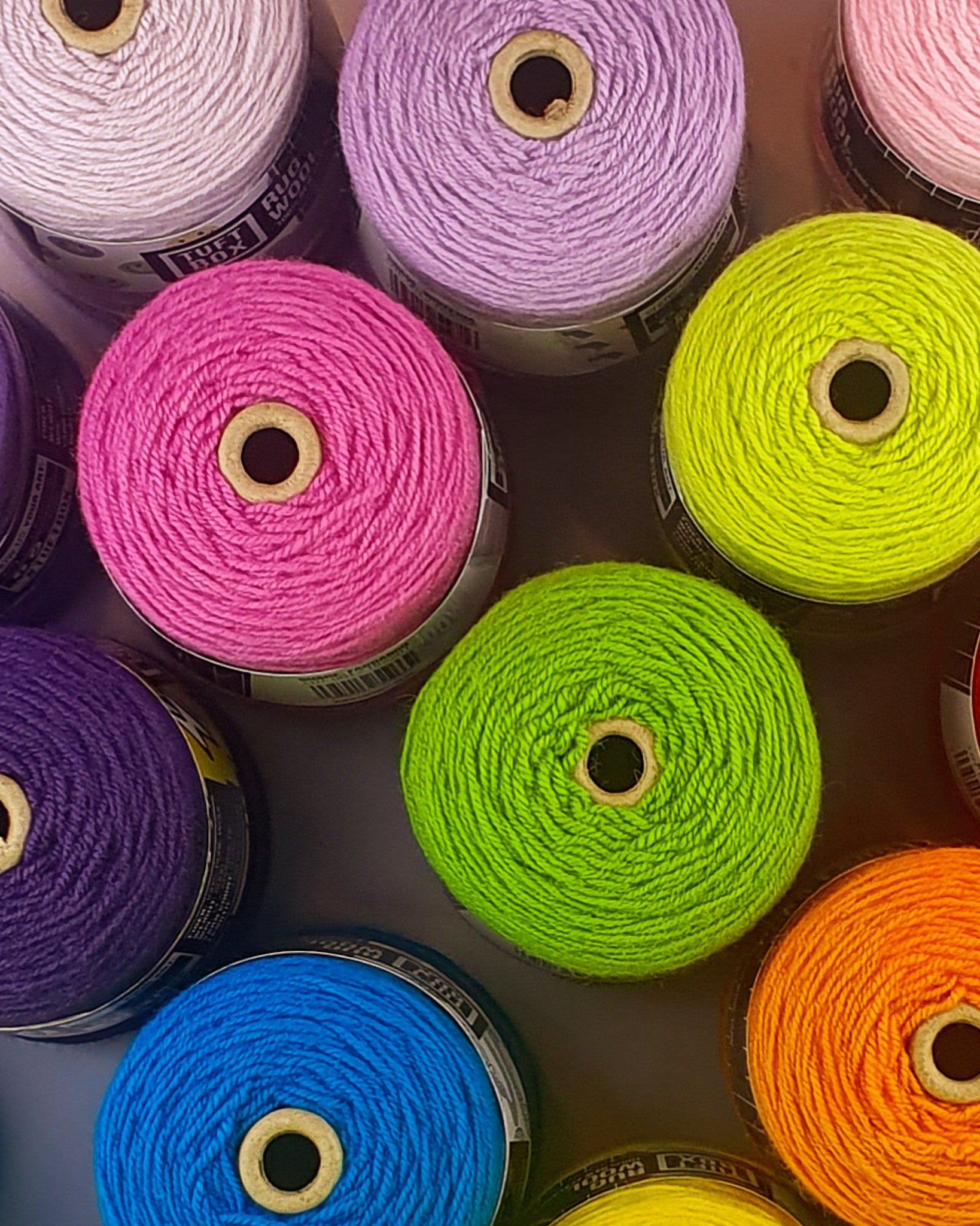 Colourful cones of rug tufting yarn