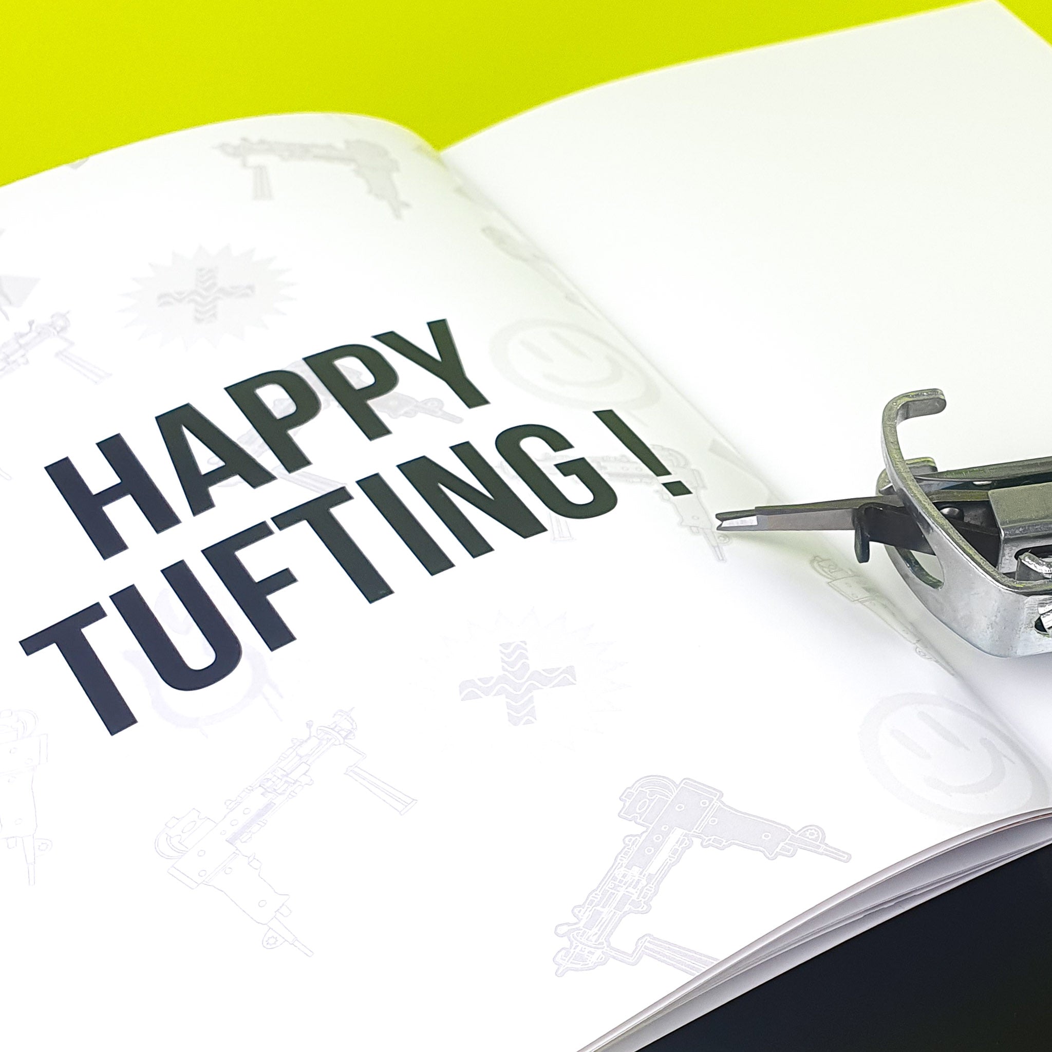 Close up of the Tuftbox AK-I tufting machine manual which reads "HAPPY TUFTING!" 