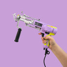 AK-V Rug Tufting Gun Held In One Hand Showing Handle Colours In A Lifestyle Image