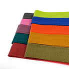 Colorful woven cotton herringbone rug binding webbings on a white background