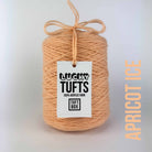 A cone of Lucky Tufts™ acrylic tufting and punch needle yarn in the colour Apricot Ice a light pastel orange