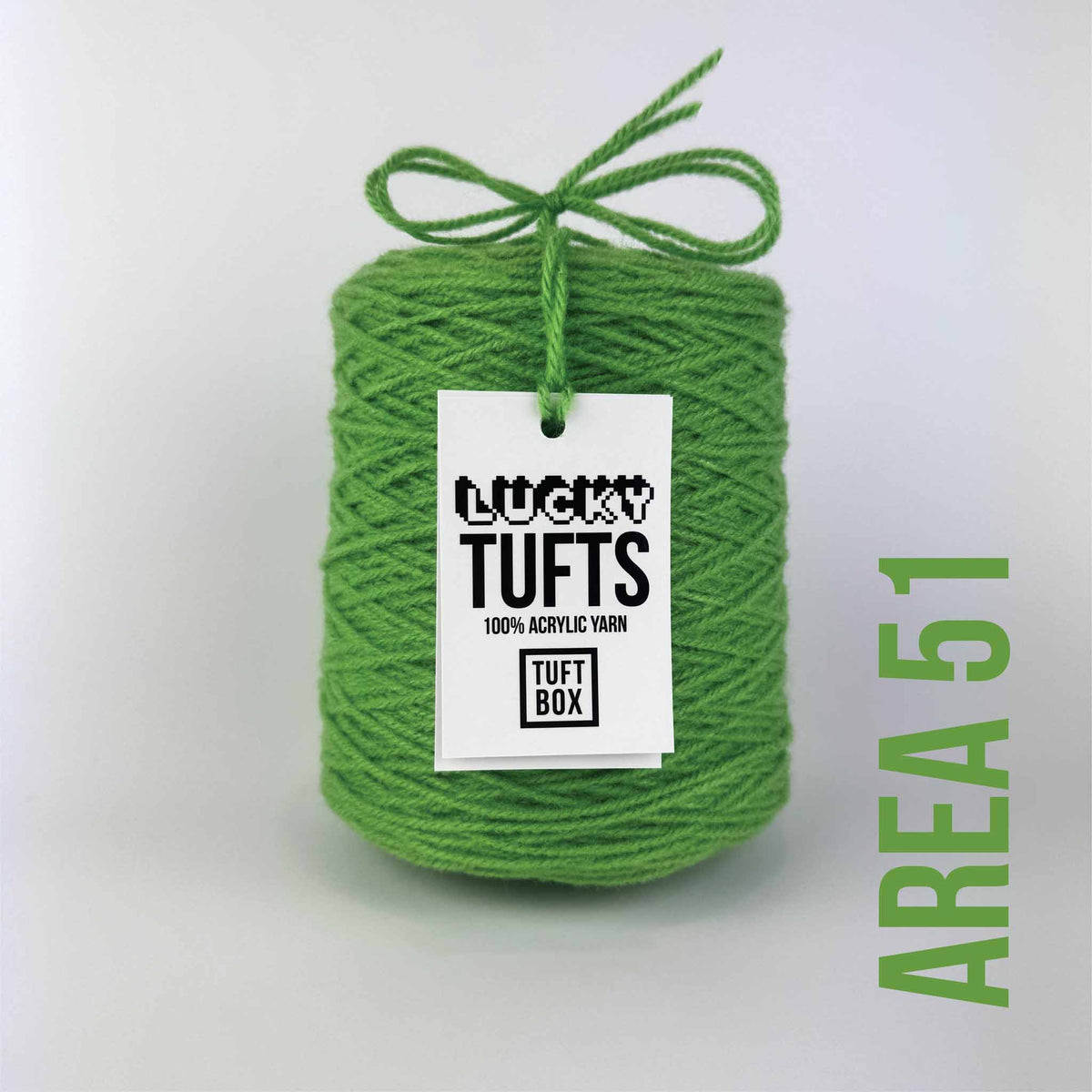 A cone of Lucky Tufts™ acrylic tufting and punch needle yarn in the colour Area 51. A high contrast, bright green.