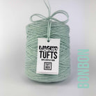 A cone of Lucky Tufts™ acrylic tufting and punch needle yarn in the colour Bonbon. A high contrast pale green.