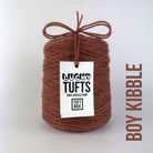 A cone of Lucky Tufts™ acrylic tufting and punch needle yarn in the colour  Boy Kibble a muted red brown 