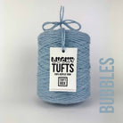 A cone of Lucky Tufts™ acrylic tufting and punch needle yarn in the colour Bubbles. A bright blue and light grey.