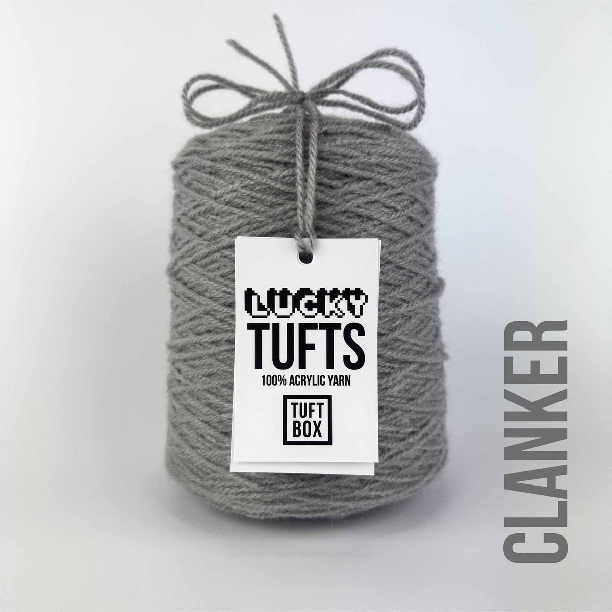 A cone of Lucky Tufts™ acrylic tufting and punch needle yarn in the colour Clanker a  grey