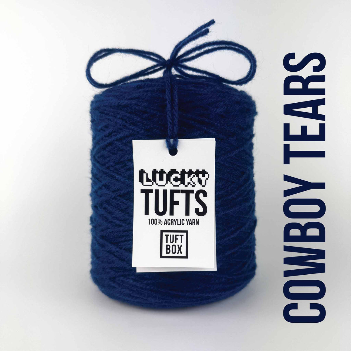 A cone of Lucky Tufts™ acrylic tufting and punch needle yarn in the colour Cowboy Tears. A dark, royal blue.