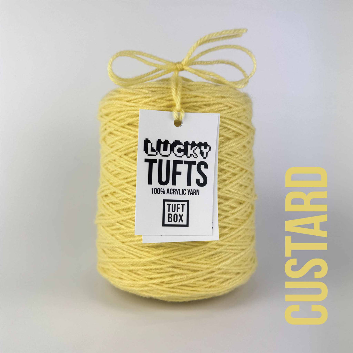 A cone of Lucky Tufts™ acrylic tufting and punch needle yarn in the colour Custard. A muted yellow.