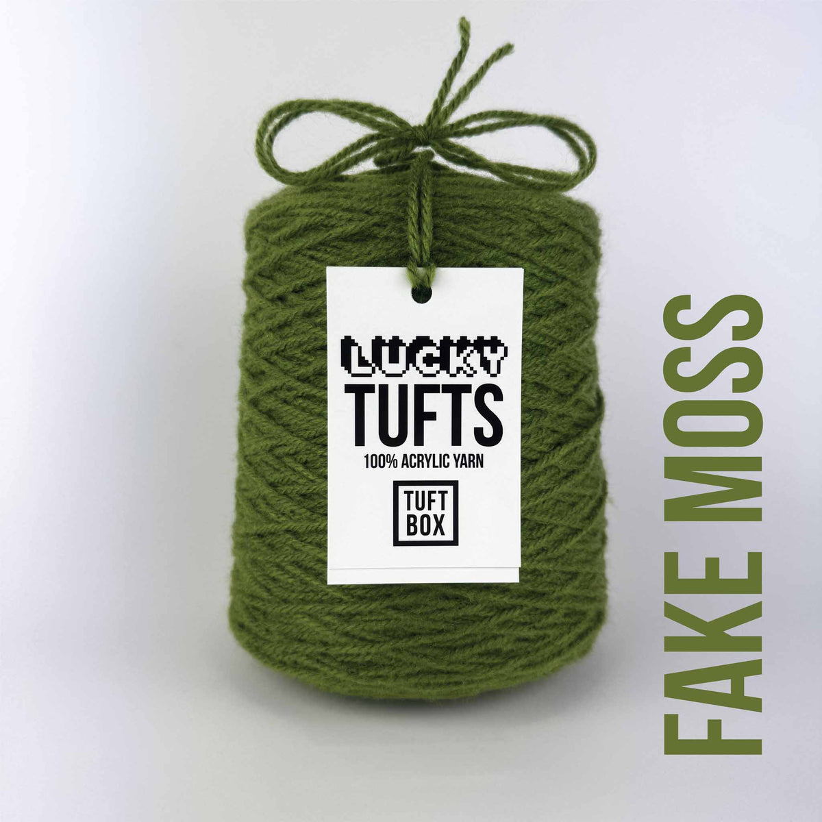 A cone of Lucky Tufts™ acrylic tufting and punch needle yarn in the colour Fake Moss. A warm green with a yellow hue. 