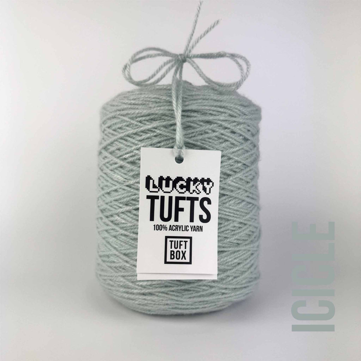 A cone of Lucky Tufts™ acrylic tufting and punch needle yarn in the colour Icicle. A whited, washed light blue.