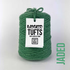 A cone of Lucky Tufts™ acrylic tufting and punch needle yarn in the colour Jaded. A strong mid-tone green.