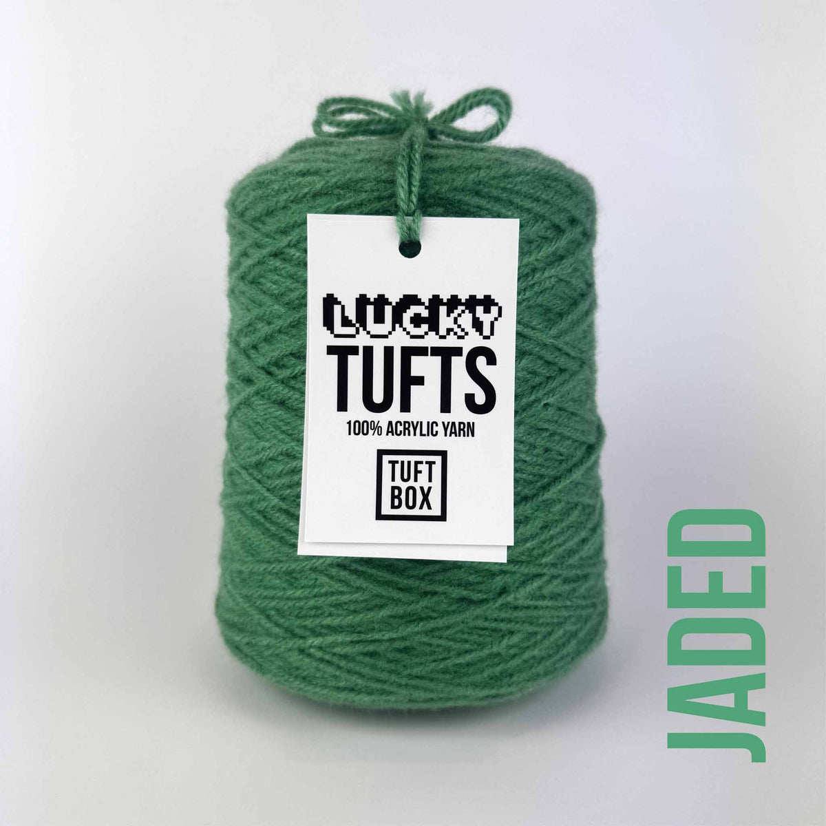 A cone of Lucky Tufts™ acrylic tufting and punch needle yarn in the colour Jaded. A strong mid-tone green.