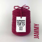 A cone of Lucky Tufts™ acrylic tufting and punch needle yarn in the colour Jammy, a thick and dark red.