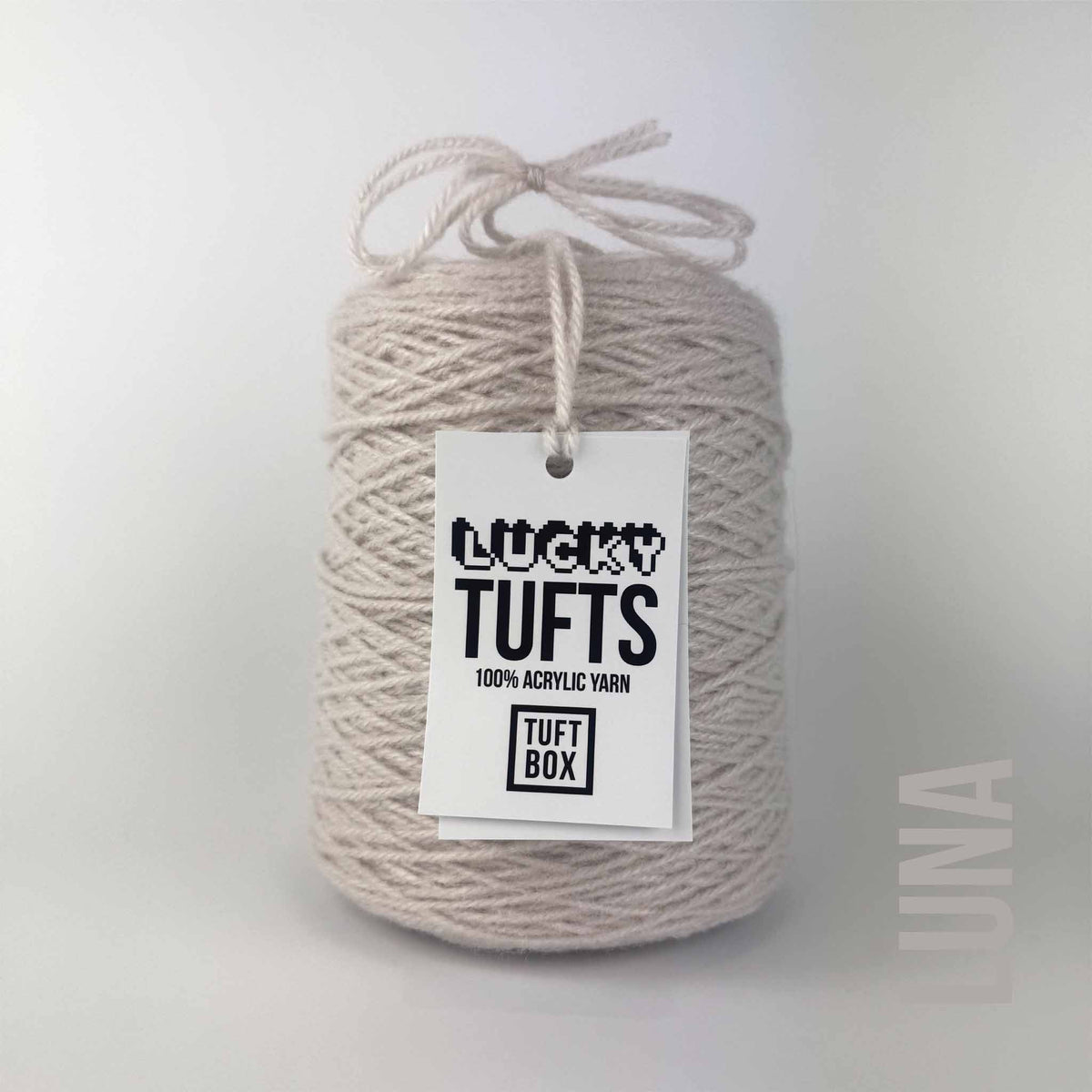 A cone of Lucky Tufts™ acrylic tufting and punch needle yarn in the colour Luna a greige grey beige colour 