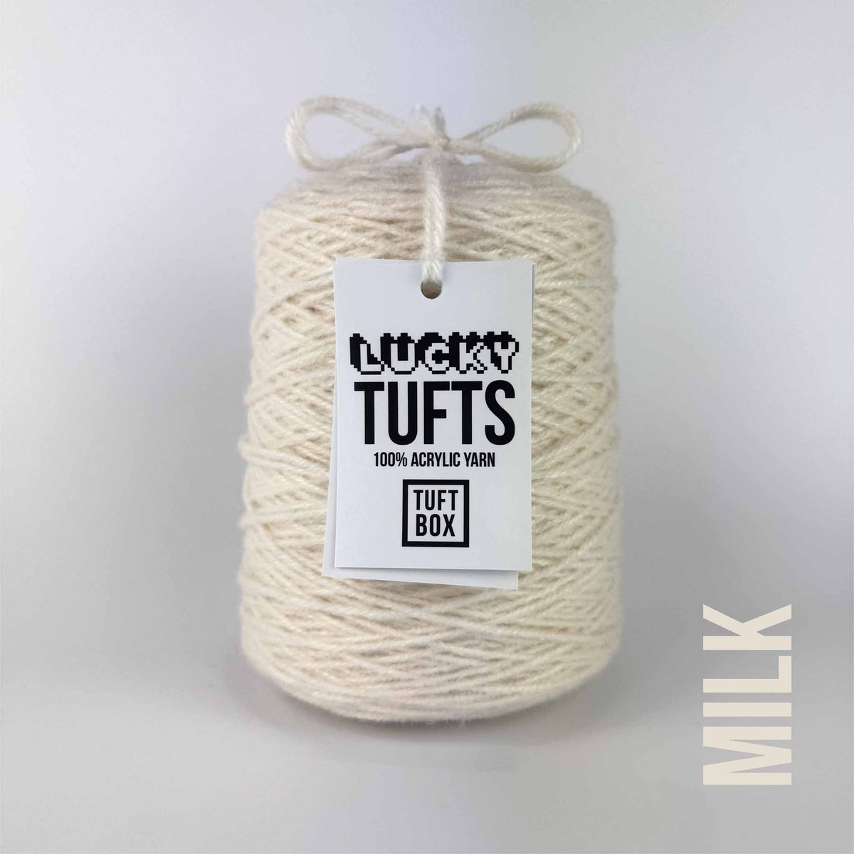 A cone of Lucky Tufts™ acrylic tufting and punch needle yarn in the colour milk a soft warm off-white 