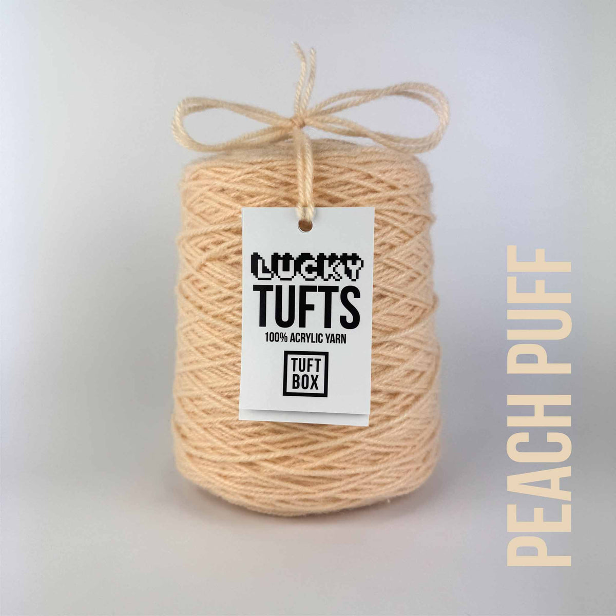 A cone of Lucky Tufts™ acrylic tufting and punch needle yarn in the colour Peach Puff a vibrant light pastel peach 