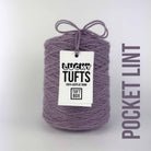 A cone of Lucky Tufts™ acrylic tufting and punch needle yarn in the colour Pocket Lint. A dry and cool mauve.