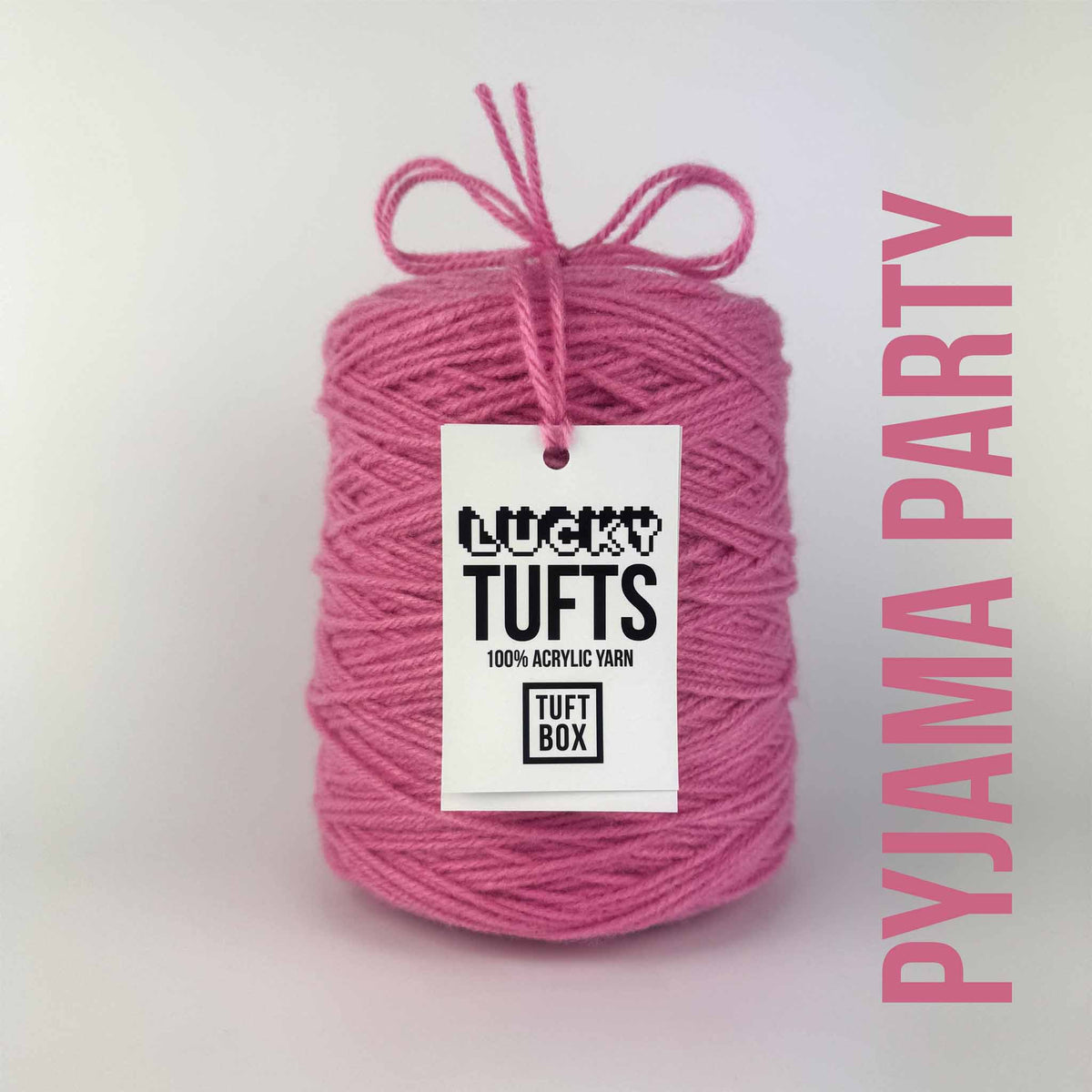 A cone of Lucky Tufts™ acrylic tufting and punch needle yarn in the colour Pyjama Party. A soft, pastel pink