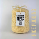 A cone of Lucky Tufts™ acrylic tufting and punch needle yarn in the colour Rice Pudding a classic cream pastel yellow