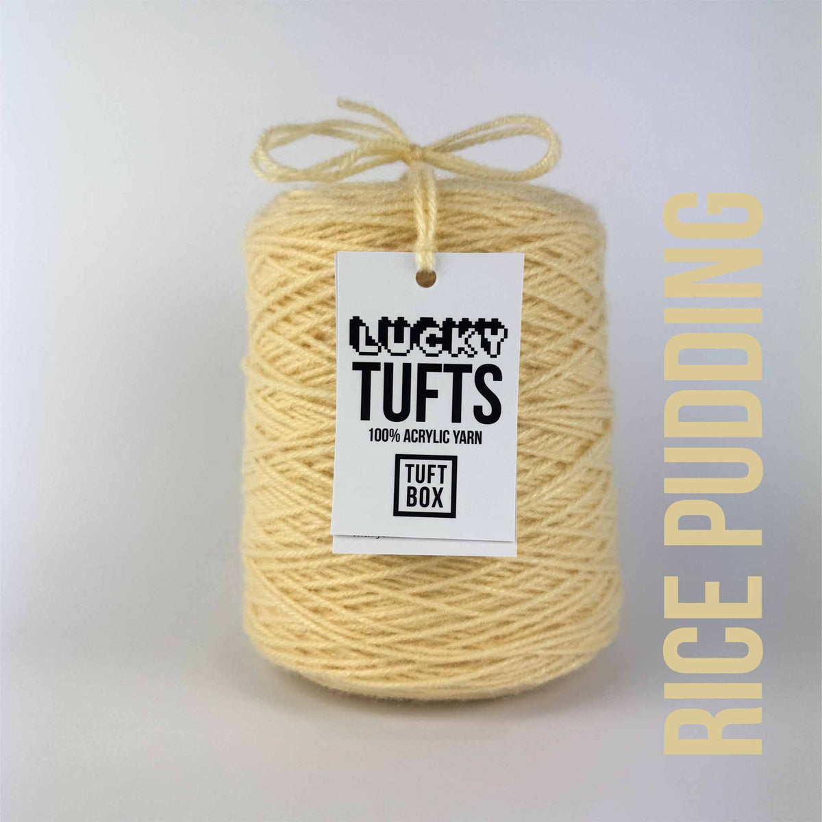 A cone of Lucky Tufts™ acrylic tufting and punch needle yarn in the colour Rice Pudding a classic cream pastel yellow