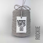 A cone of Lucky Tufts™ acrylic tufting and punch needle yarn in the colour Rockie a warm light grey 