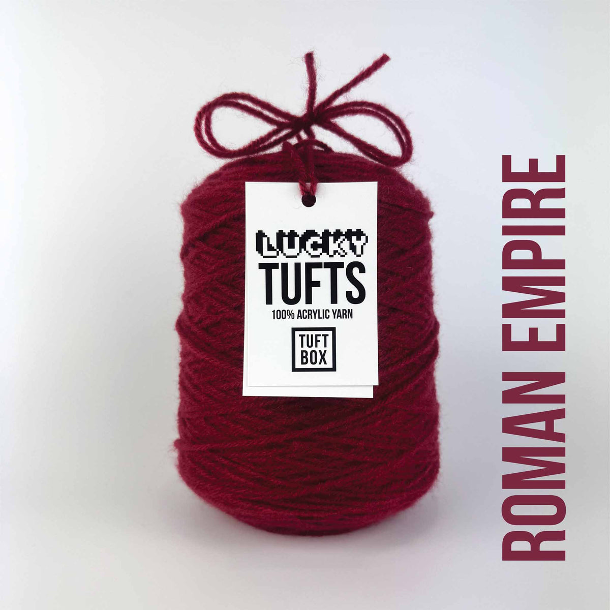 A cone of Lucky Tufts™ acrylic tufting and punch needle yarn in the colour Roman Empire a deep dark red 