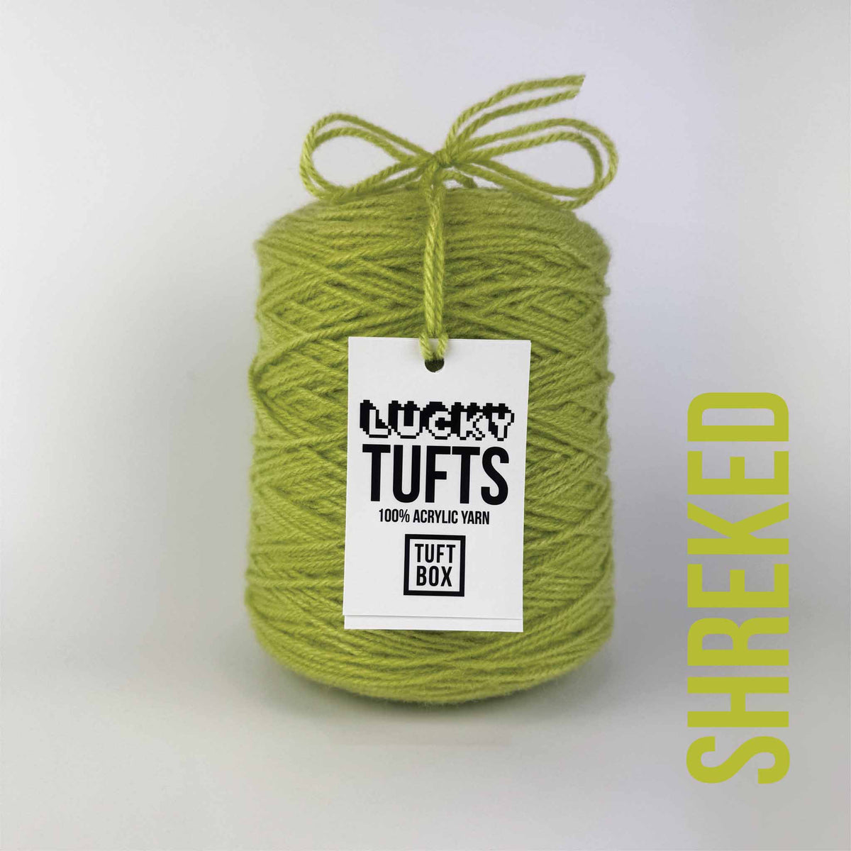 A cone of Lucky Tufts™ acrylic tufting and punch needle yarn in the colour Shreked. A green with a rich yellow midtone.