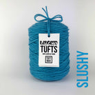 A cone of Lucky Tufts™ acrylic tufting and punch needle yarn in the colour Slushy. A bright blue with washed out tones.