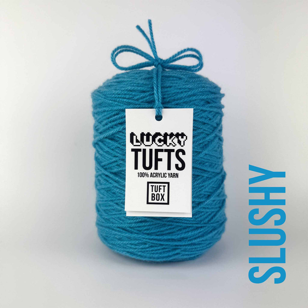 A cone of Lucky Tufts™ acrylic tufting and punch needle yarn in the colour Slushy. A bright blue with washed out tones.