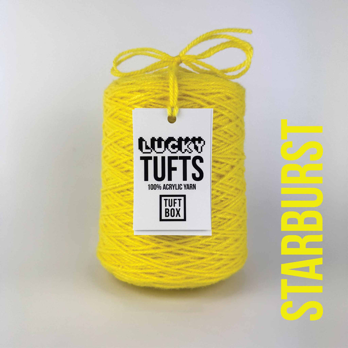 A cone of Lucky Tufts™ acrylic tufting and punch needle yarn in the colour Starburst. A bright and full, electric yellow.