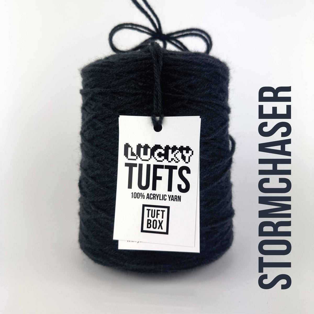 A cone of Lucky Tufts™ acrylic tufting and punch needle yarn in the colour Stormchaser a deep petrol blue black 