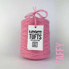 A cone of Lucky Tufts™ acrylic tufting and punch needle yarn in the colour Taffy. A bright pink.